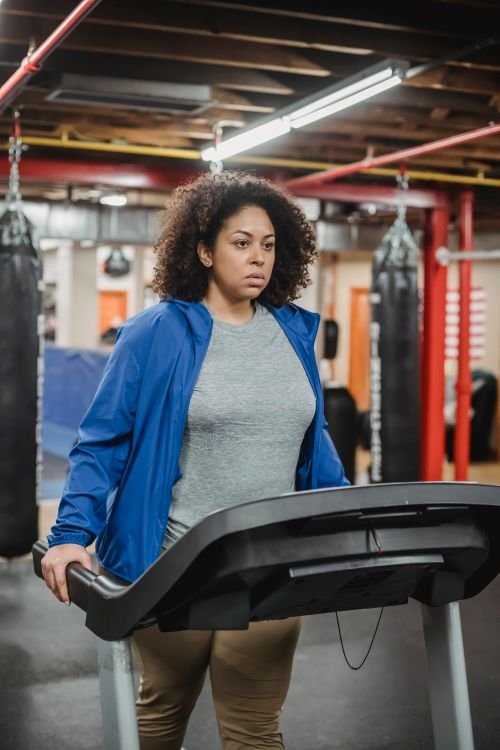 Woman walking on a treadmill during a workout session
